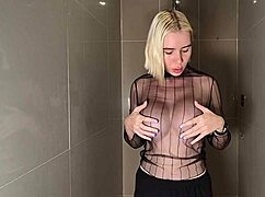 blonde beauty with huge shaved tits gets wet showering see-through pussy