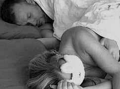 he sneaks up on his blindfolded wife in bed fingers her shaved pussy to orgasm then blasts cum on her pretty face