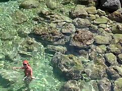 Wet Shaved Pussy Flashes from Yellow Trunks in Blue Beach Water!