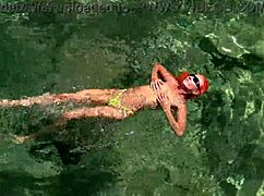 Wet Shaved Pussy Flashes from Yellow Trunks in Blue Beach Water!