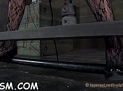 shackled brunette babe punished hardcore with toys in garage