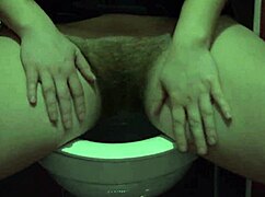 Blonde in miniskirt lifts panties to flash hairy pussy then pisses hard on toilet?