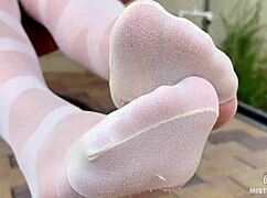 enjoy seductive nylon feet on a bench in white patterned pantyhose