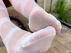 enjoy seductive nylon feet on a bench in white patterned pantyhose