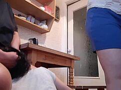 girlfriend licks pussy under table while housekeeper washes dishes