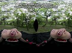 Hotkinkyjo in old apple orchard picks red apples during virtual reality session