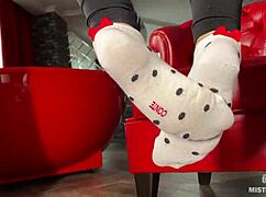 goddess plays with her feet in socks and barefoot under the table